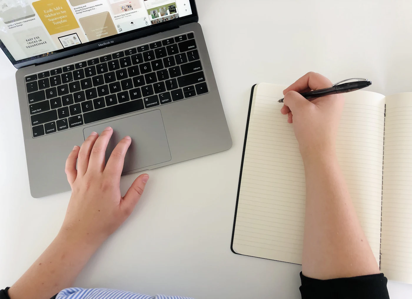 Person organizing documents beside a laptop before contacting an assistance provider