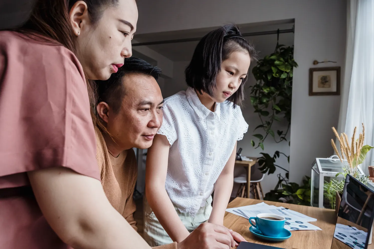 Family using a laptop together at home