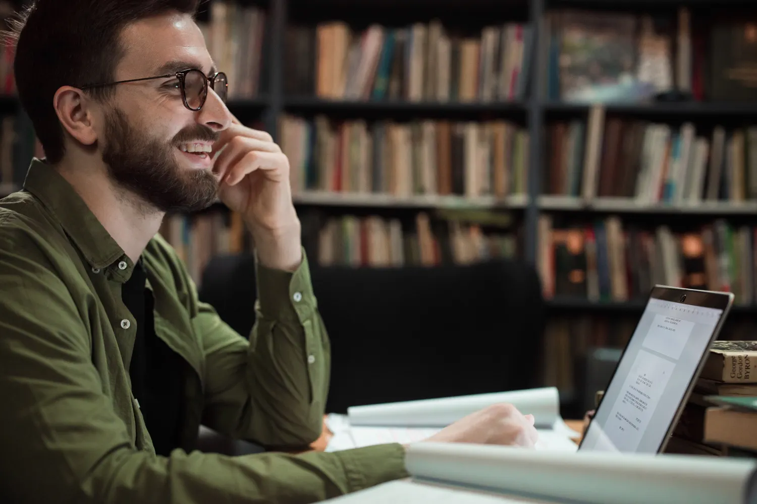 Adult using a laptop in a public library