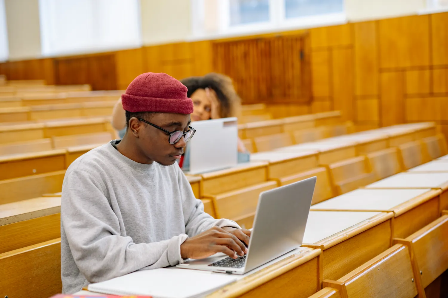 Students using laptops in a university lecture hall